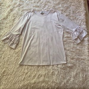 Dainty Jewell’s white ruffle shirt